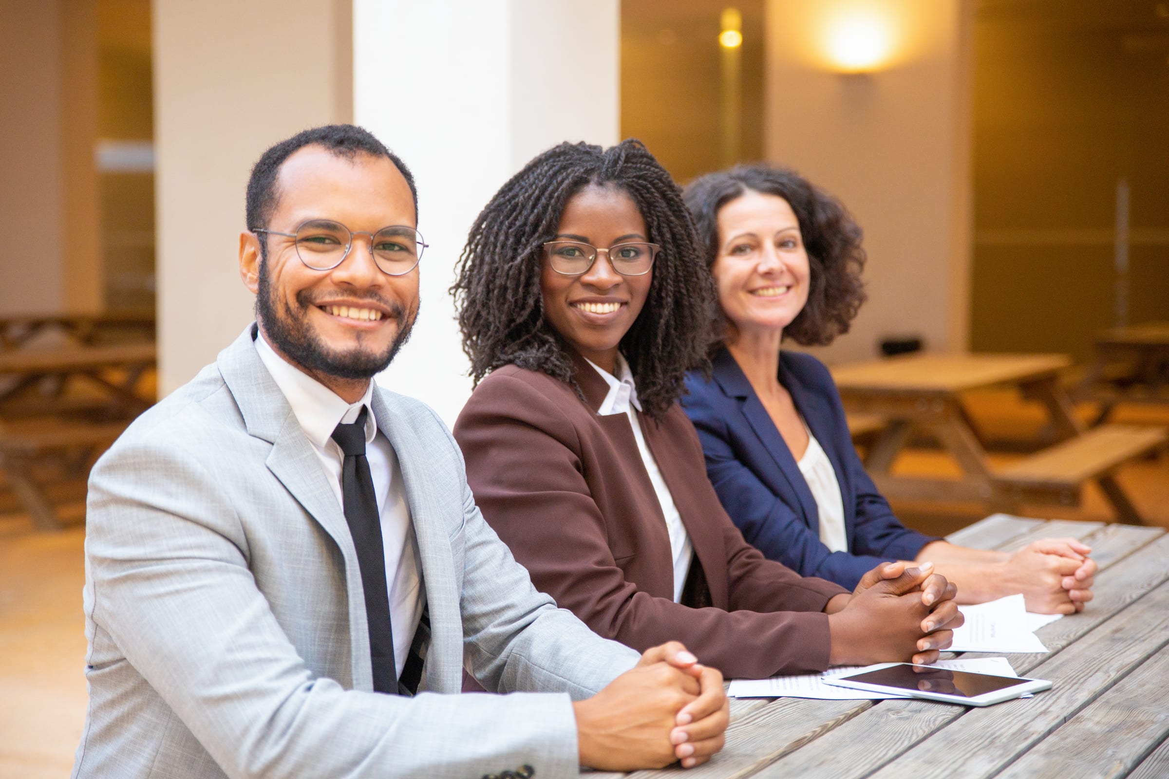 The Hagios Advisory team smiling together in a meeting room