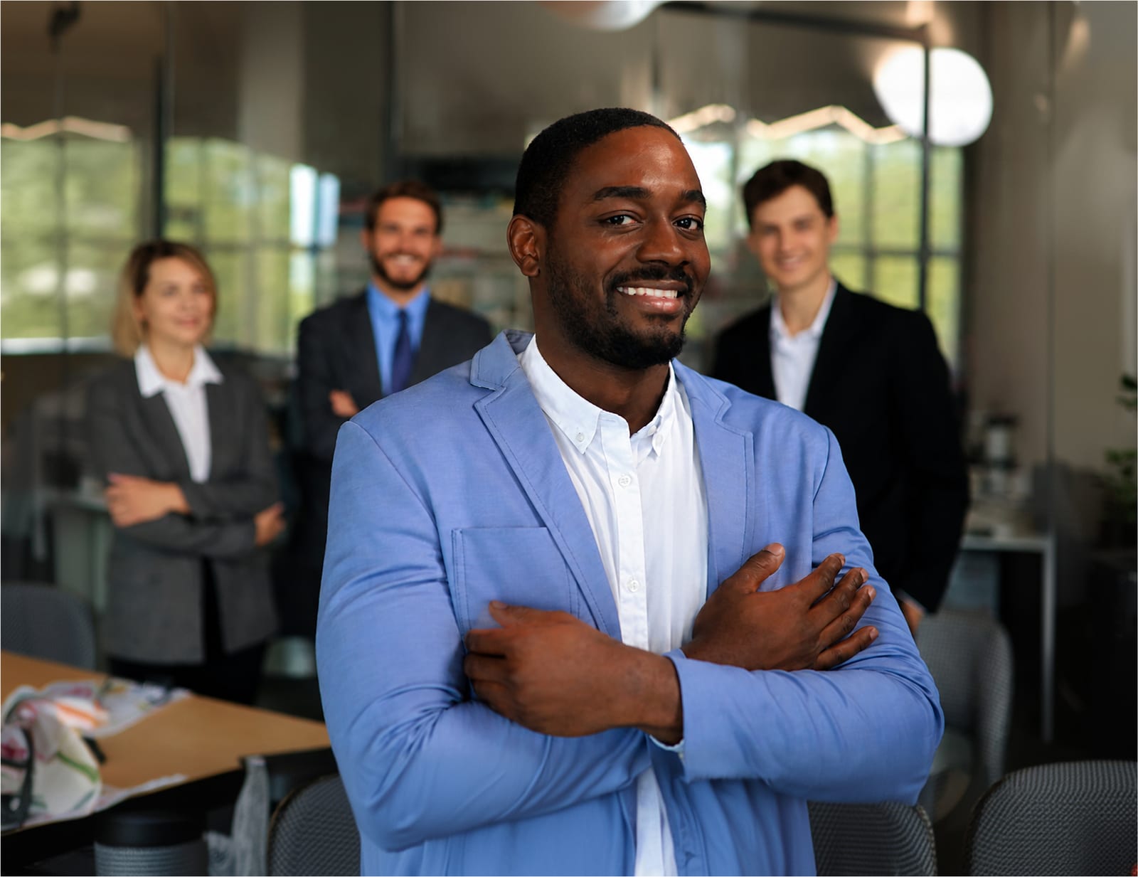 A Hagios Advisory consultant with colleagues in a modern office